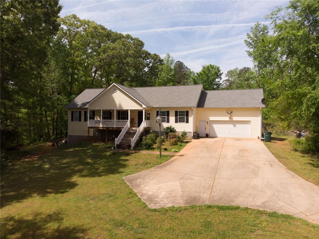 120 Norman Road Covington, GA 30014 - Photo 2 of 31 a front view of a house with yard patio and lake view