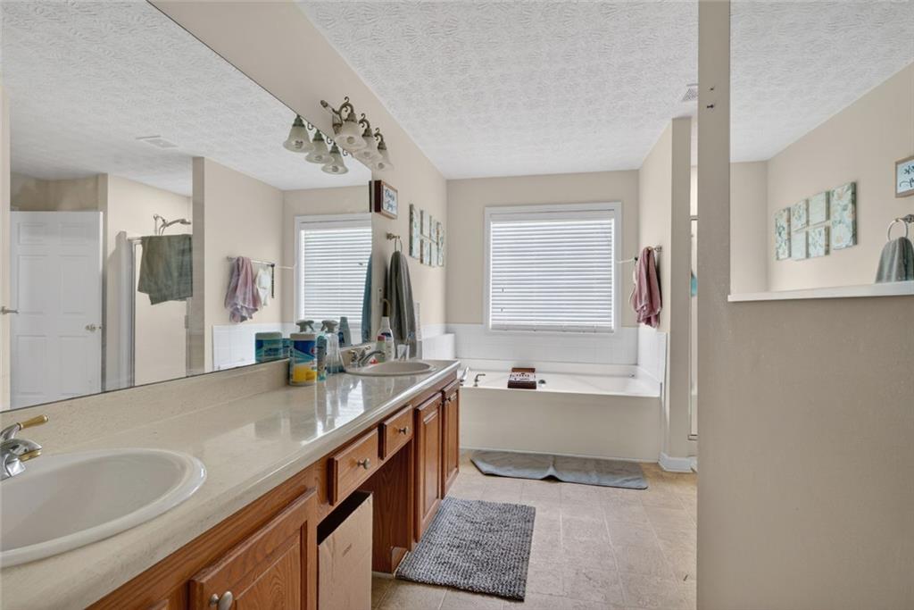 120 Norman Road Covington, GA 30014 - Photo 21 of 31 a spacious bathroom with a tub sink and mirror