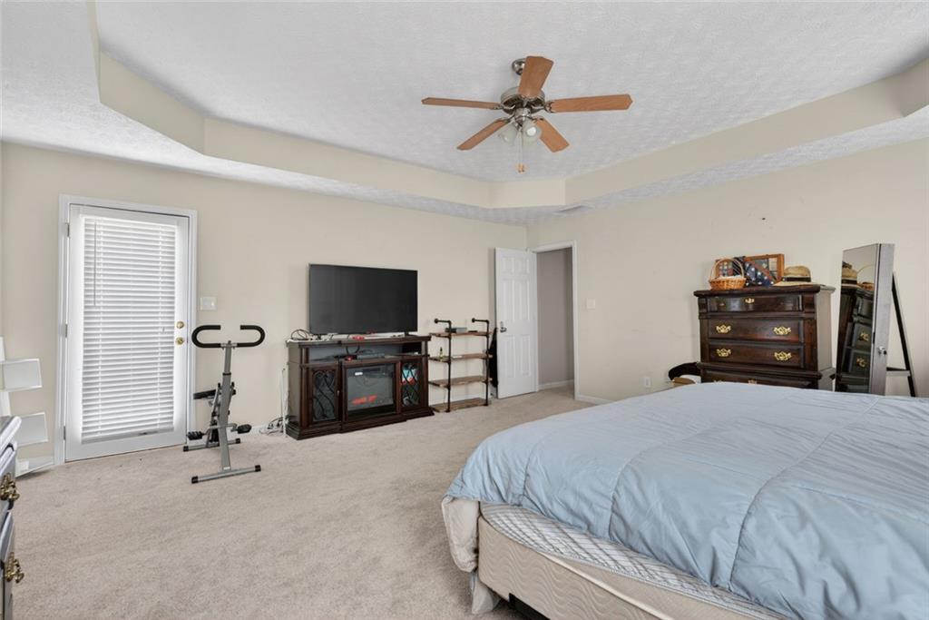 120 Norman Road Covington, GA 30014 - Photo 24 of 31 a bedroom with a bed and a flat tv screen on dresser