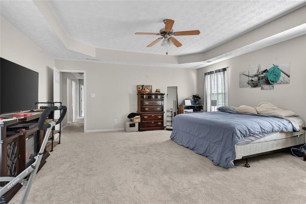 120 Norman Road Covington, GA 30014 - Photo 26 of 31 a spacious bedroom with a bed and a flat screen tv