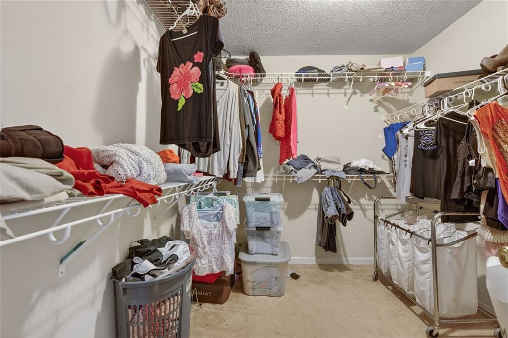 120 Norman Road Covington, GA 30014 - Photo 27 of 31 a view of walk in closet with clothes