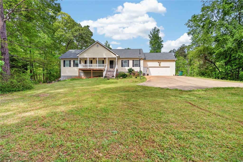 120 Norman Road Covington, GA 30014 - Photo 3 of 31 a view of a house next to a big yard with large trees