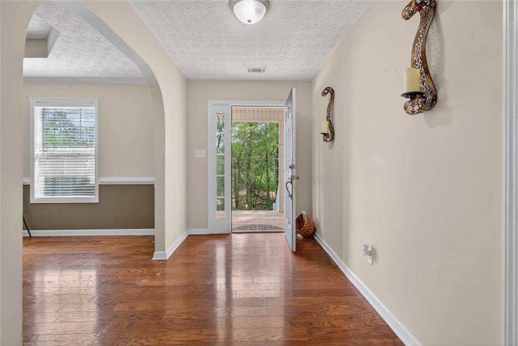 120 Norman Road Covington, GA 30014 - Photo 4 of 31 a view of an entryway with wooden floor and windows
