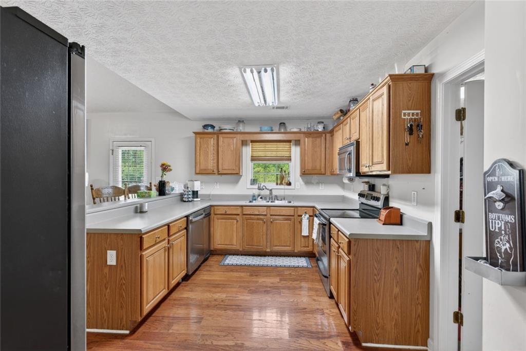120 Norman Road Covington, GA 30014 - Photo 6 of 31 a kitchen with stainless steel appliances a sink stove and cabinets