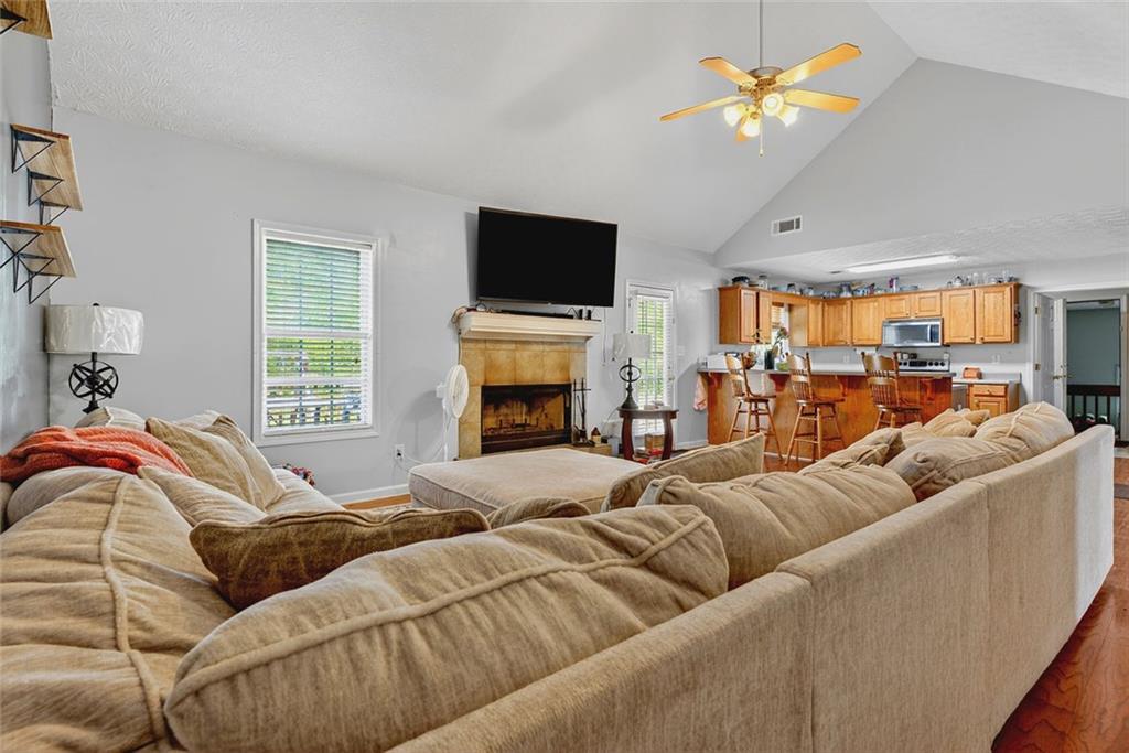 120 Norman Road Covington, GA 30014 - Photo 8 of 31 a living room with furniture a fireplace and a flat screen tv