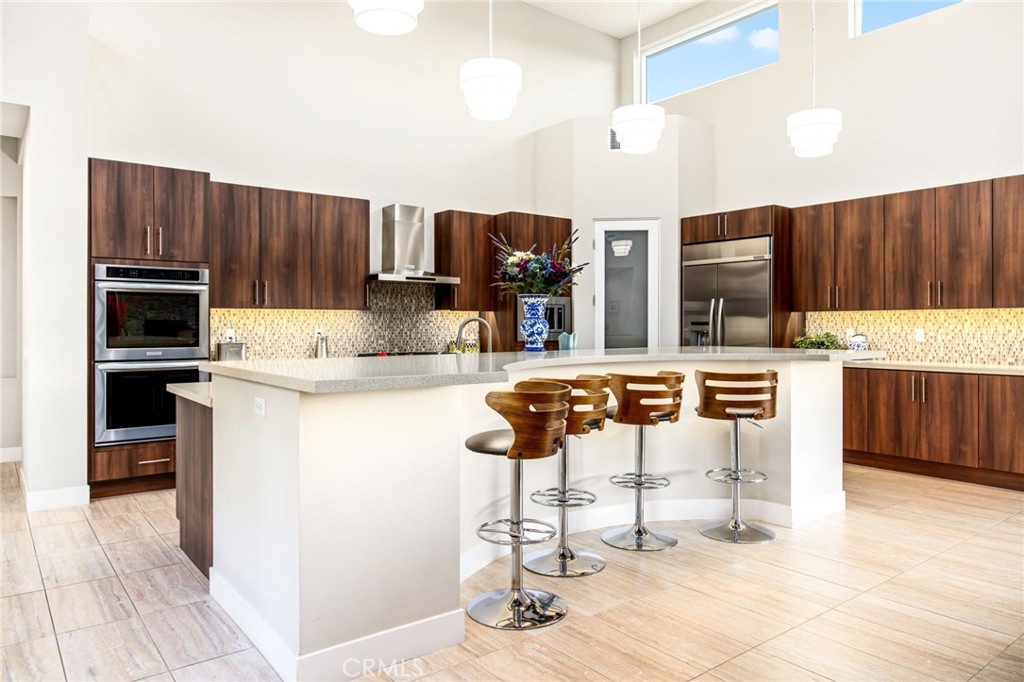 15 Via Montagna Rancho Mirage, CA 92270 - Photo 27 of 75 a kitchen with stainless steel appliances kitchen island granite countertop a refrigerator and a stove top oven