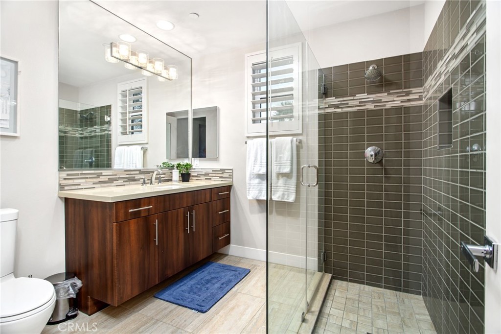 15 Via Montagna Rancho Mirage, CA 92270 - Photo 52 of 75 a bathroom with a double vanity sink a toilet a mirror and shower