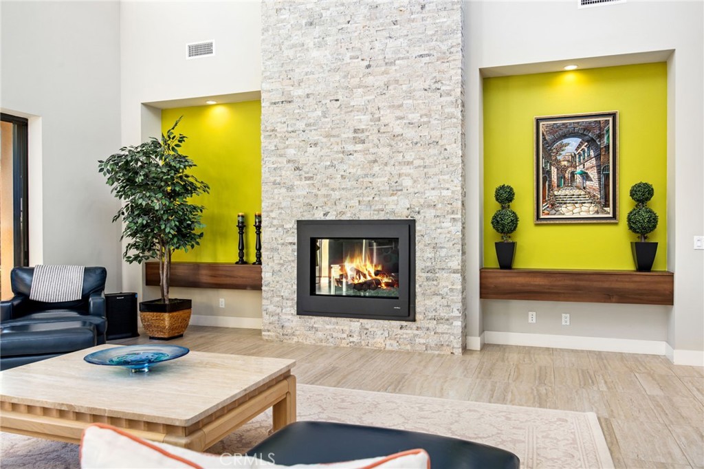 15 Via Montagna Rancho Mirage, CA 92270 - Photo 7 of 75 a living room with fireplace and a potted plant