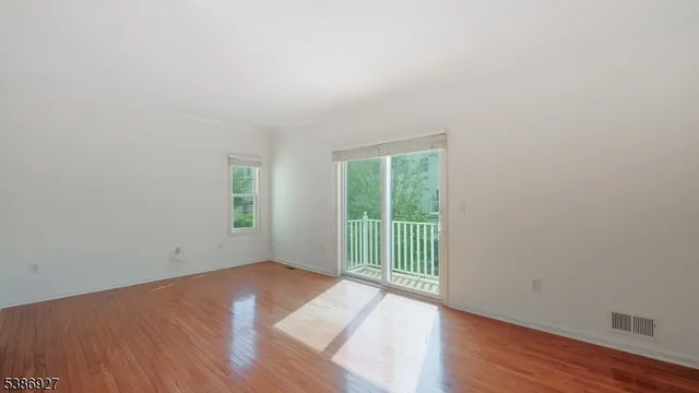 wooden floor in an empty room with a window