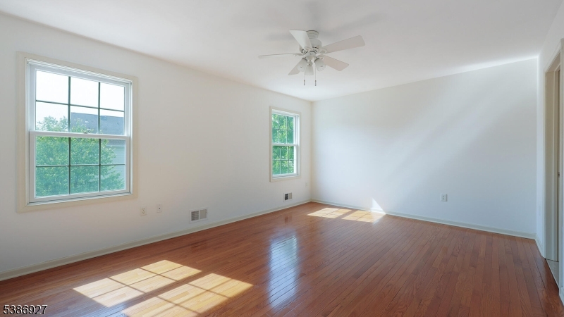 16 Riga Court Scotch Plains, NJ 07076 - Photo 18 of 33 wooden floor in an empty room with a window