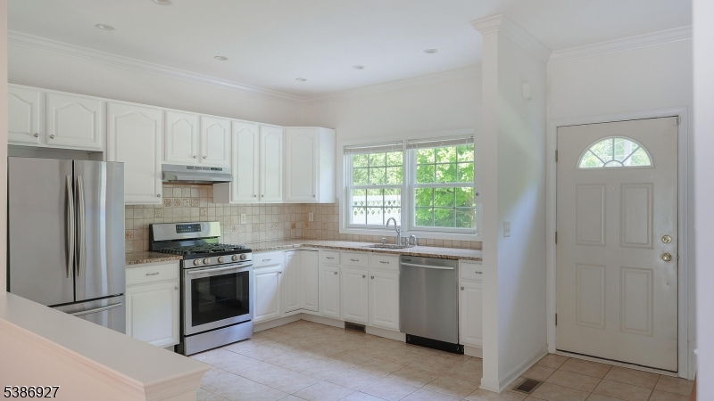 16 Riga Court Scotch Plains, NJ 07076 - Photo 6 of 33 a kitchen with cabinets stainless steel appliances and a window