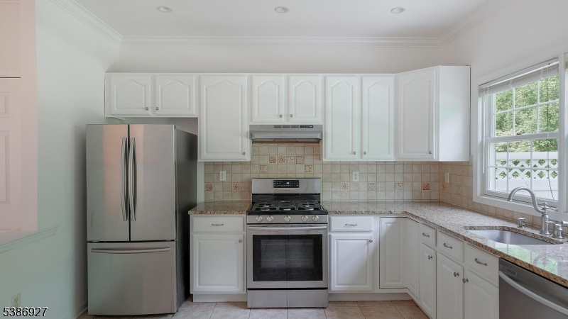 16 Riga Court Scotch Plains, NJ 07076 - Photo 8 of 33 a kitchen with cabinets stainless steel appliances and a sink
