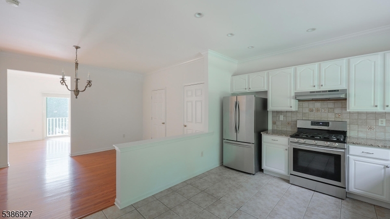 16 Riga Court Scotch Plains, NJ 07076 - Photo 9 of 33 a kitchen with stainless steel appliances a refrigerator and a stove top oven