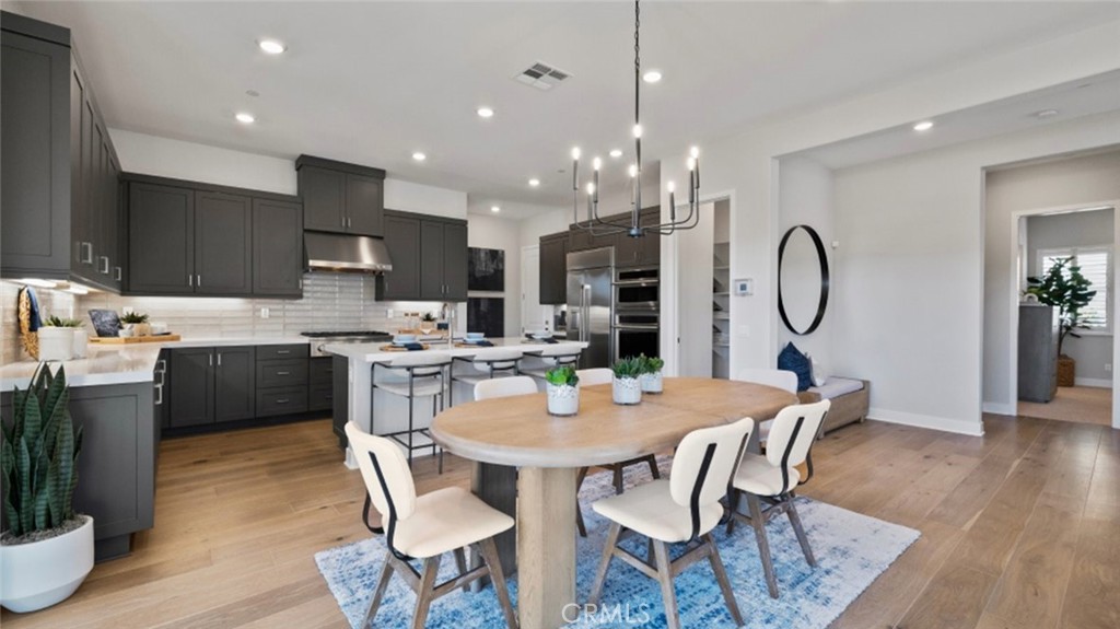 280 Sunrise Road Rancho Mission Viejo, CA 92694 - Photo 1 of 1 a view of a dining room with furniture a kitchen and chandelier