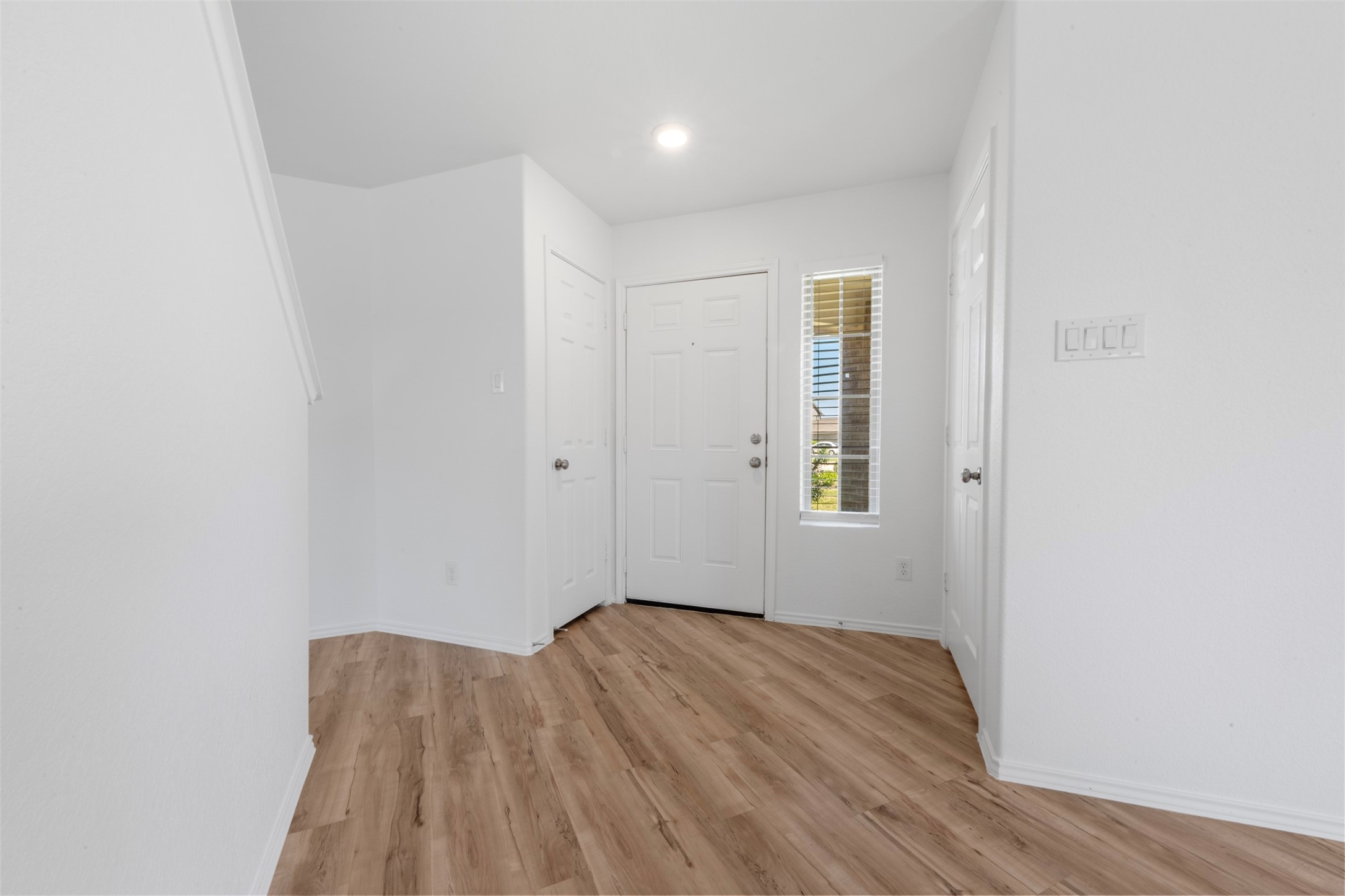 14602 Broadbury Pond Road Rosharon, TX 77583 - Photo 5 of 22 an empty room with wooden floor and windows