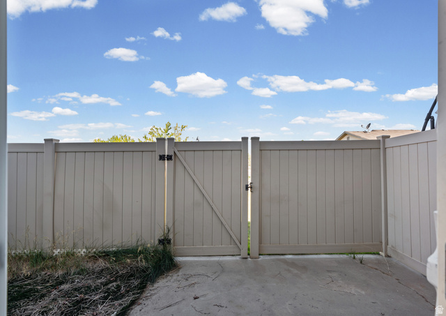 652 West 800 North, Unit 45 Clinton, UT 84015 - Photo 17 of 17 Private patio area with a light-colored privacy fence and an access gate