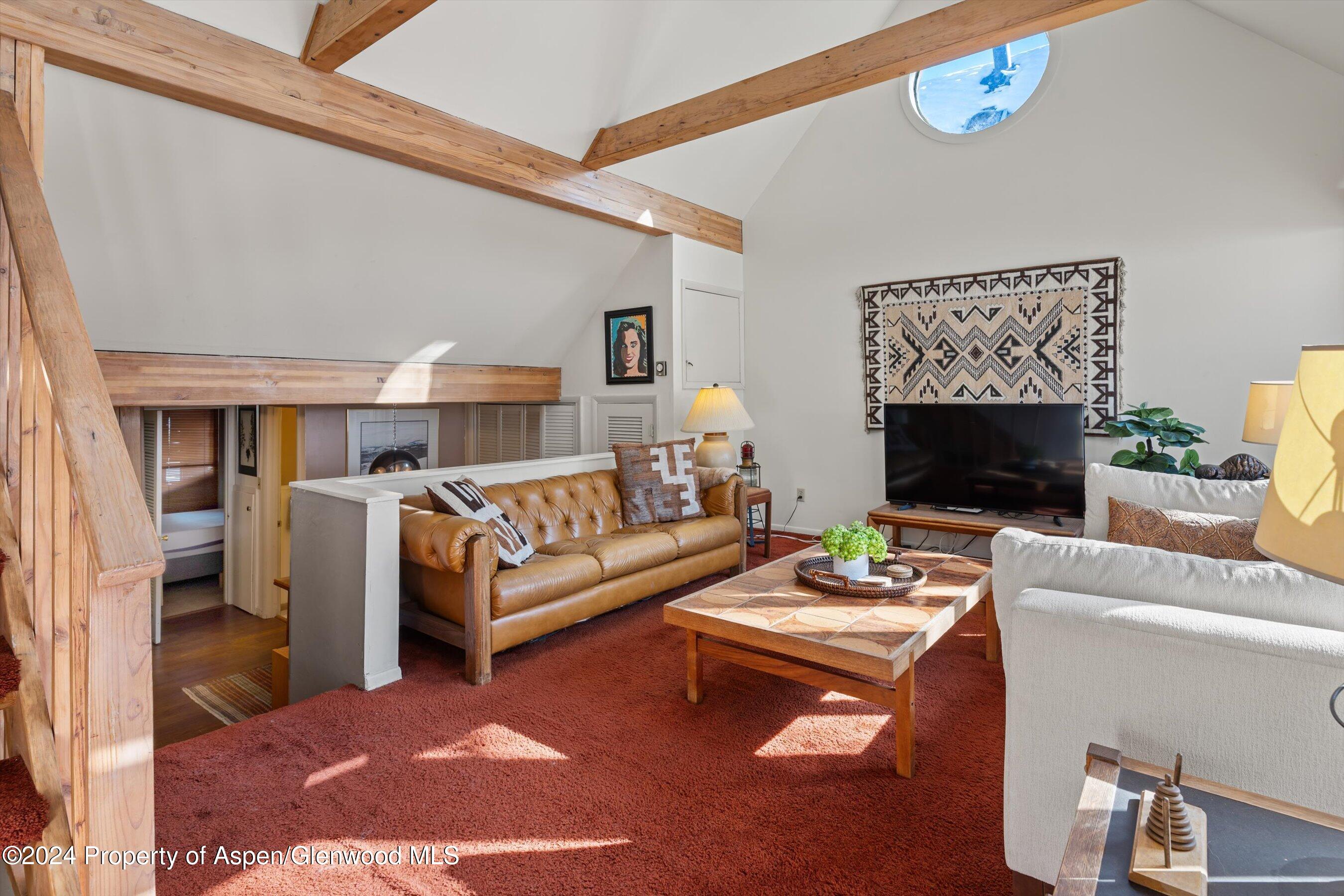 a living room with furniture a fireplace and a table