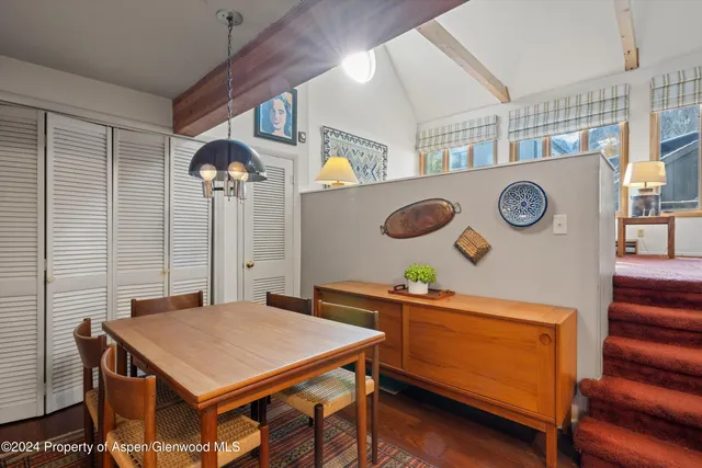 a kitchen with a table and a clock