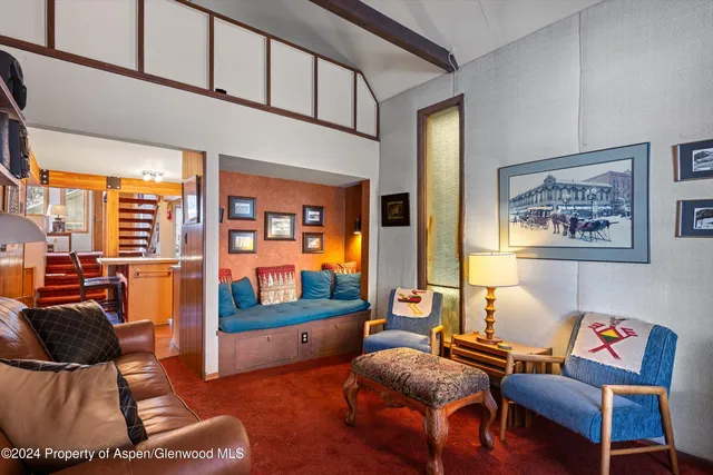 a living room with furniture and a floor to ceiling window