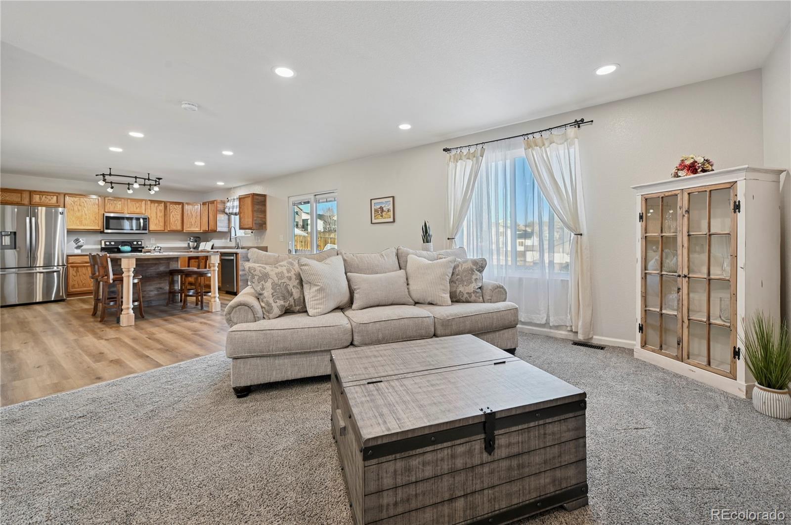 795 Winebrook Way Fountain, CO 80817 - Photo 14 of 41 a living room with furniture and a large window