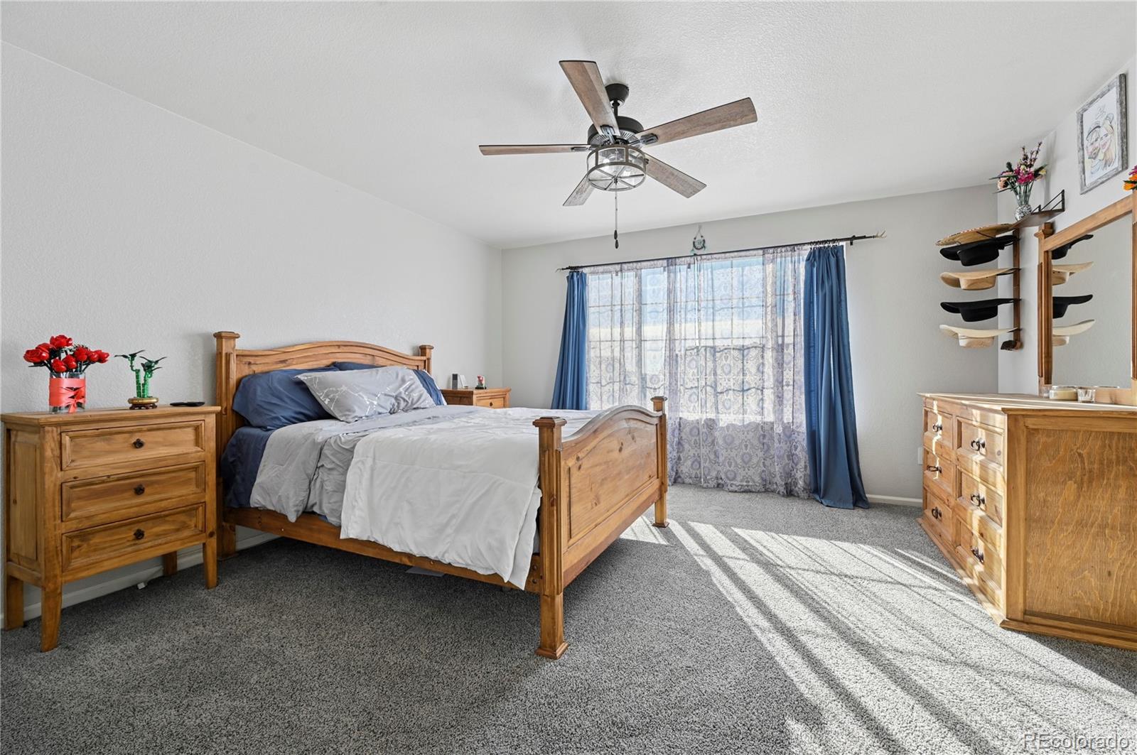 795 Winebrook Way Fountain, CO 80817 - Photo 19 of 41 a bedroom with a bed and a chandelier