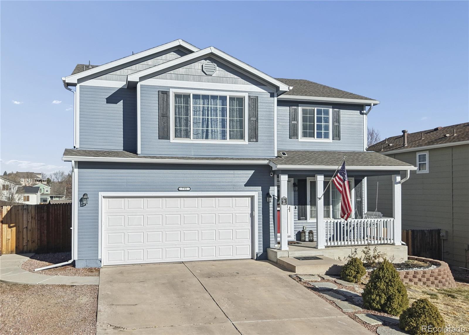 795 Winebrook Way Fountain, CO 80817 - Photo 2 of 41 a front view of a house with a garage
