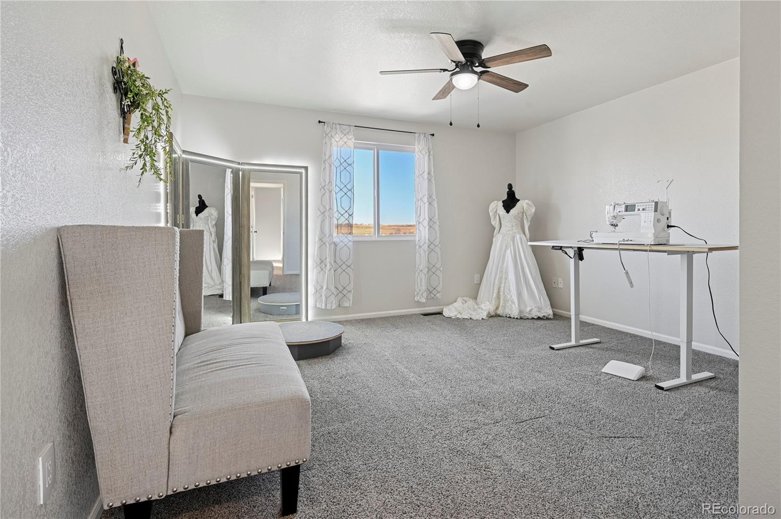 795 Winebrook Way Fountain, CO 80817 - Photo 22 of 41 a living room with furniture and a ceiling fan