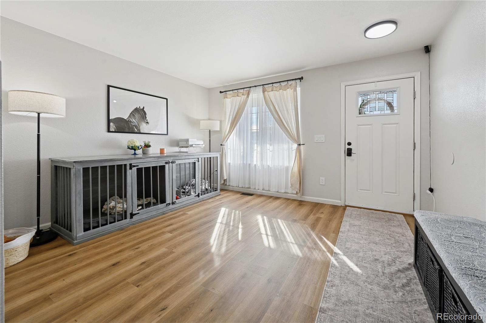 795 Winebrook Way Fountain, CO 80817 - Photo 5 of 41 an empty room with wooden floor and windows