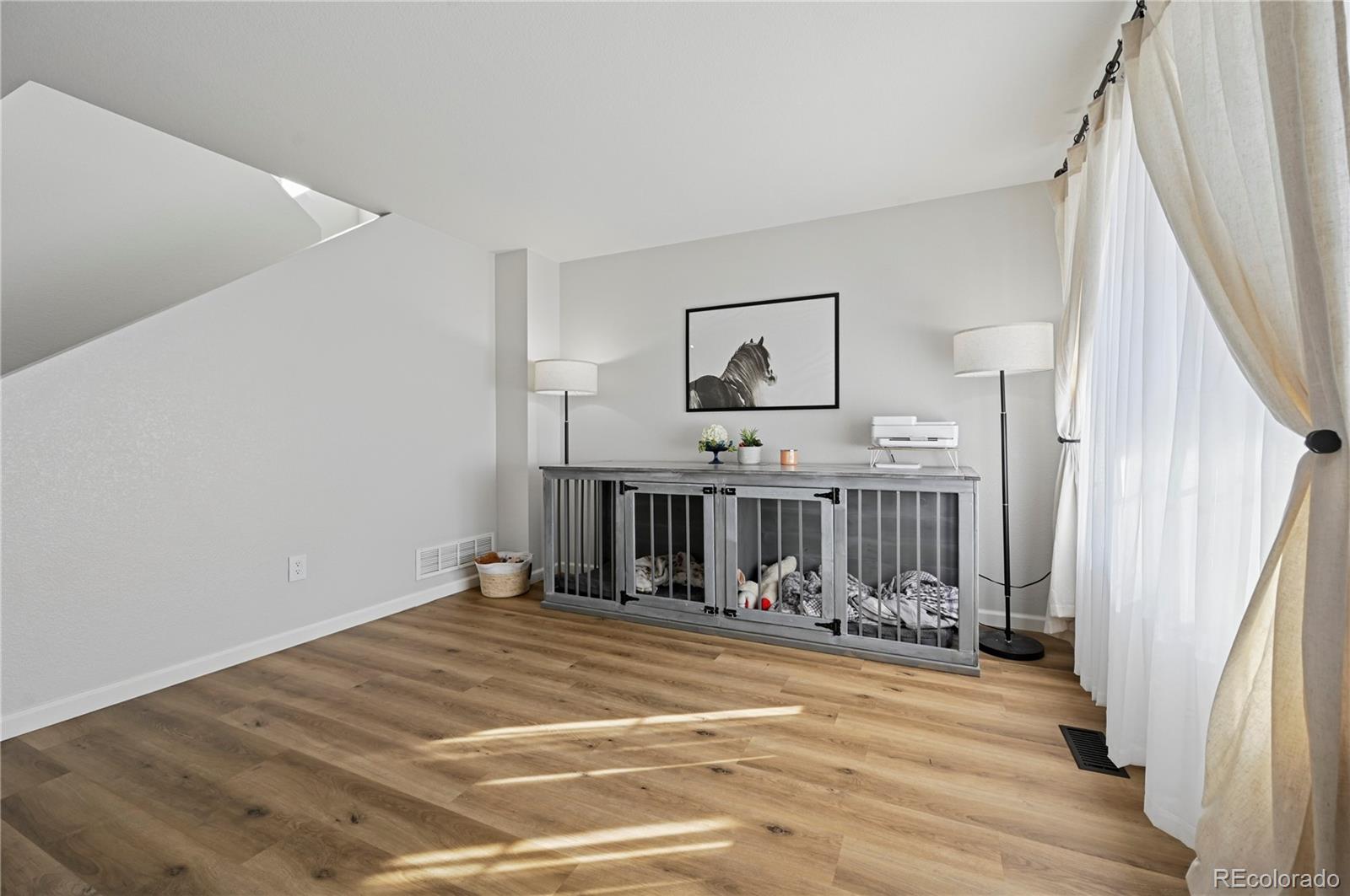 795 Winebrook Way Fountain, CO 80817 - Photo 6 of 41 a view of a room with shelves and wooden floor