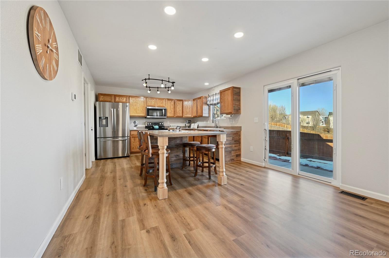 795 Winebrook Way Fountain, CO 80817 - Photo 8 of 41 an open kitchen with a table and chairs
