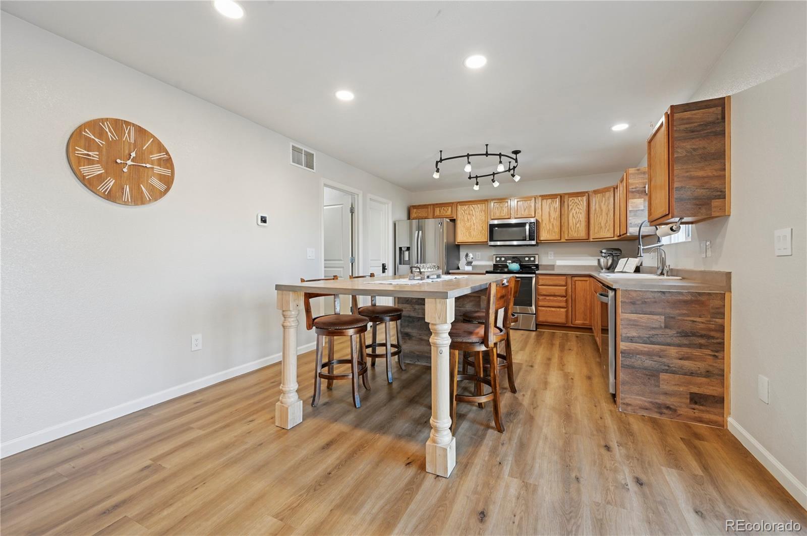 795 Winebrook Way Fountain, CO 80817 - Photo 9 of 41 a view of a dining room with furniture window and wooden floor