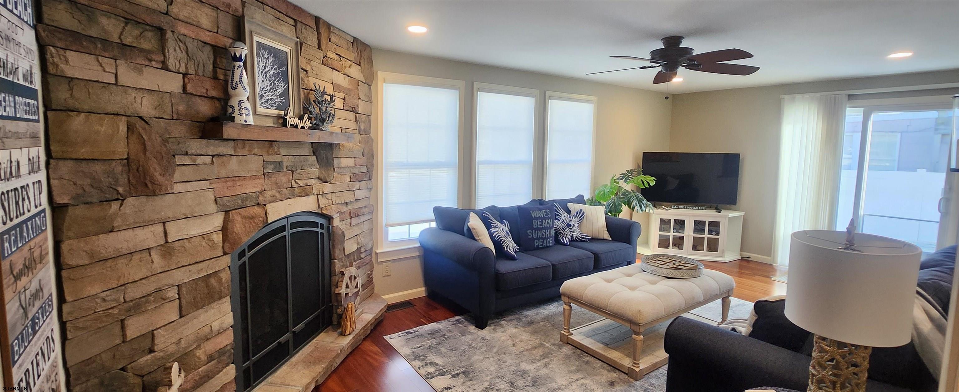 5217 Harbor Beach Boulevard, Unit SEA POINT Brigantine, NJ 08203 - Photo 14 of 38 a living room with furniture a flat screen tv and a fireplace