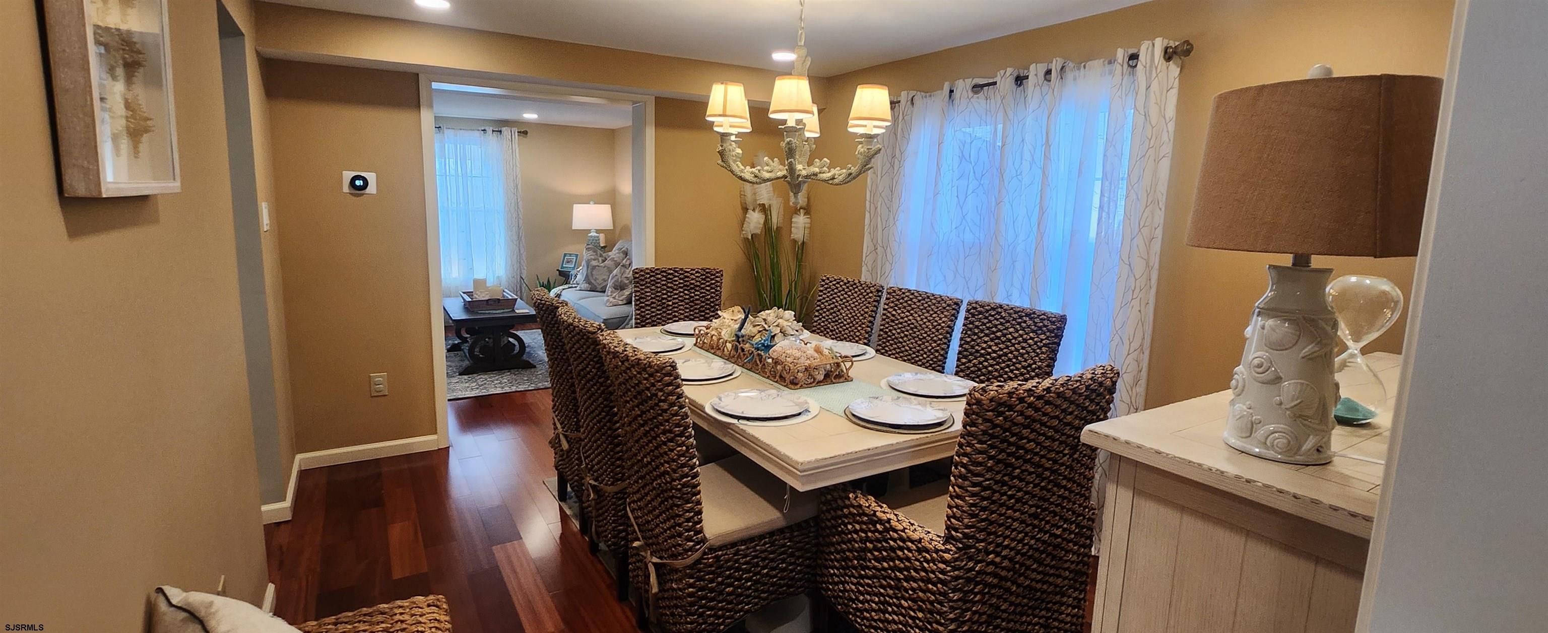 5217 Harbor Beach Boulevard, Unit SEA POINT Brigantine, NJ 08203 - Photo 16 of 38 a view of a dining room with furniture and chandelier
