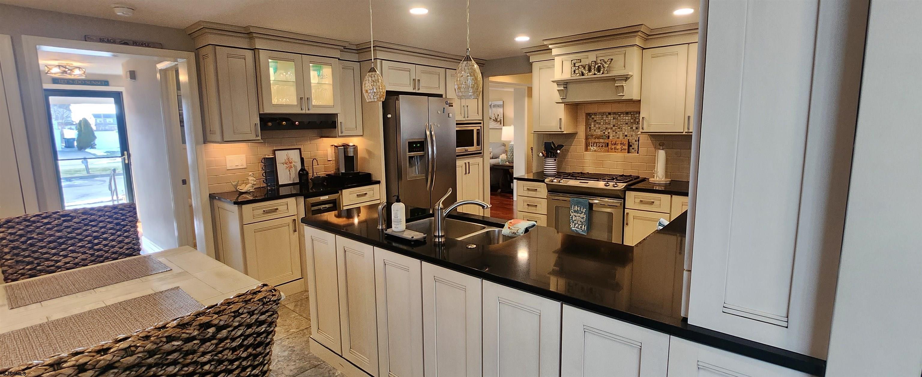 5217 Harbor Beach Boulevard, Unit SEA POINT Brigantine, NJ 08203 - Photo 25 of 38 a kitchen with a sink appliances and cabinets