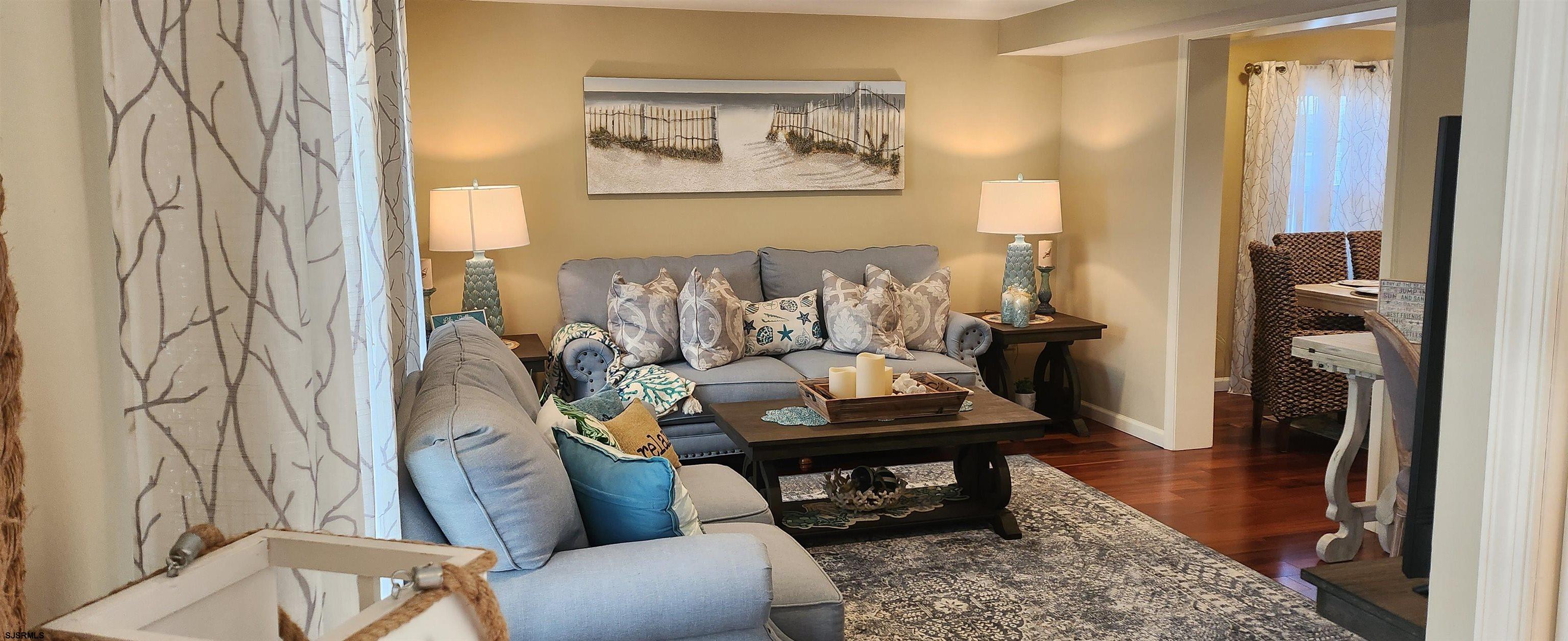 5217 Harbor Beach Boulevard, Unit SEA POINT Brigantine, NJ 08203 - Photo 3 of 38 a living room with furniture and a rug
