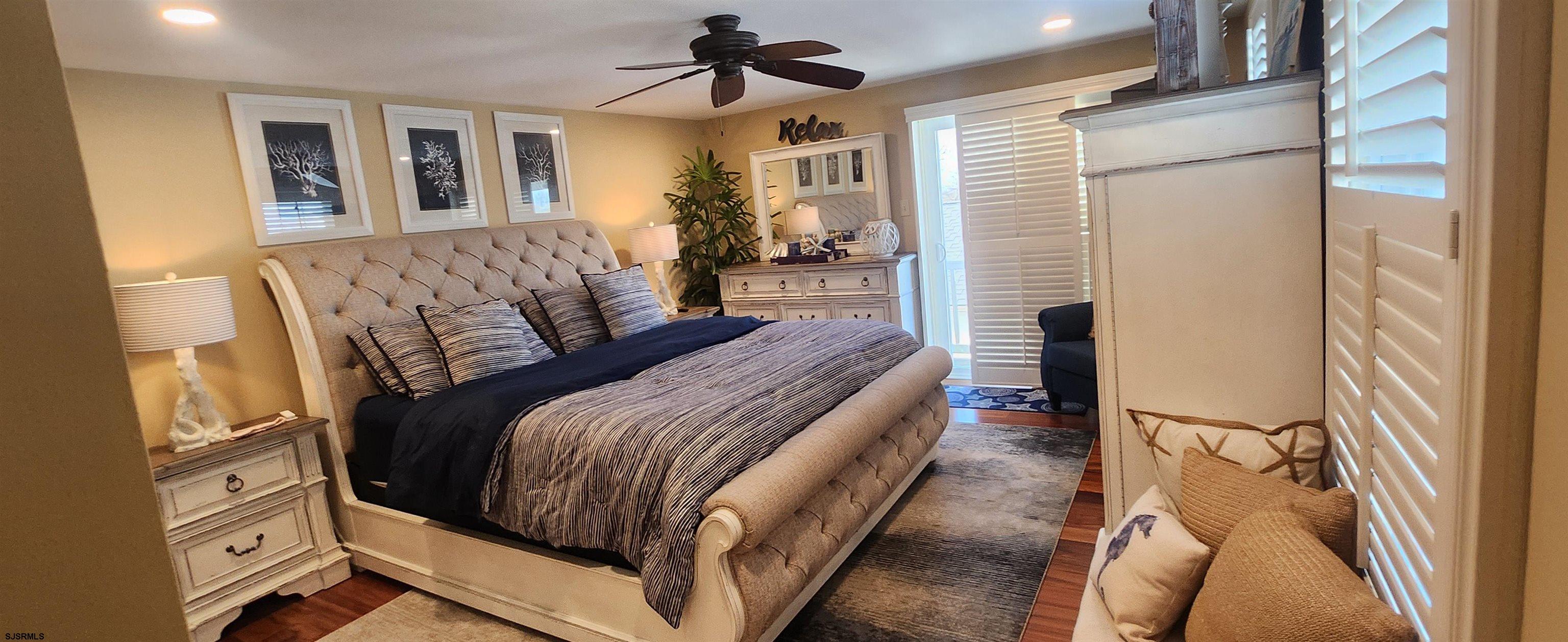 5217 Harbor Beach Boulevard, Unit SEA POINT Brigantine, NJ 08203 - Photo 34 of 38 a bedroom with a bed couch and a window
