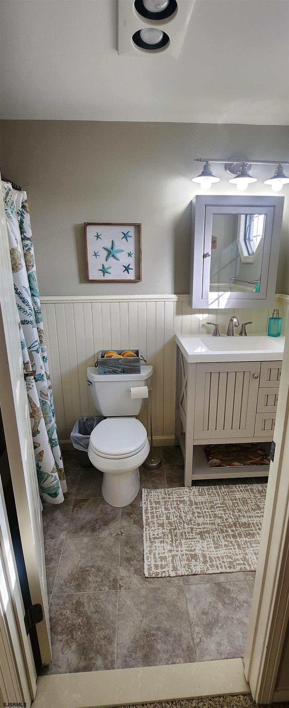 5217 Harbor Beach Boulevard, Unit SEA POINT Brigantine, NJ 08203 - Photo 38 of 38 a bathroom with a sink a toilet and a mirror