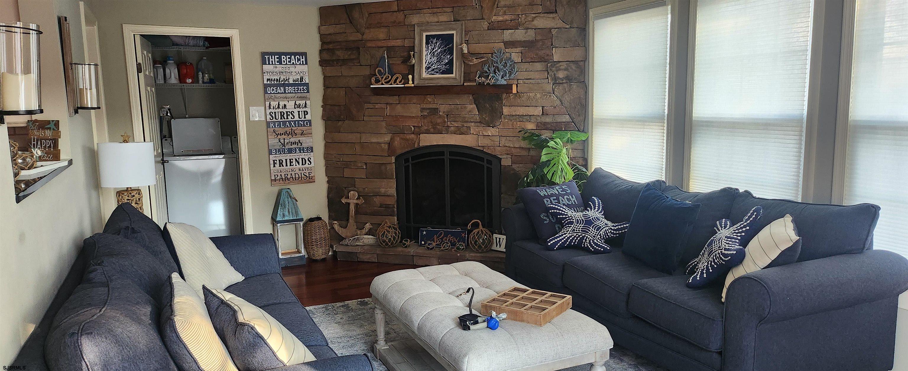 5217 Harbor Beach Boulevard, Unit SEA POINT Brigantine, NJ 08203 - Photo 7 of 38 a living room with furniture and a fireplace
