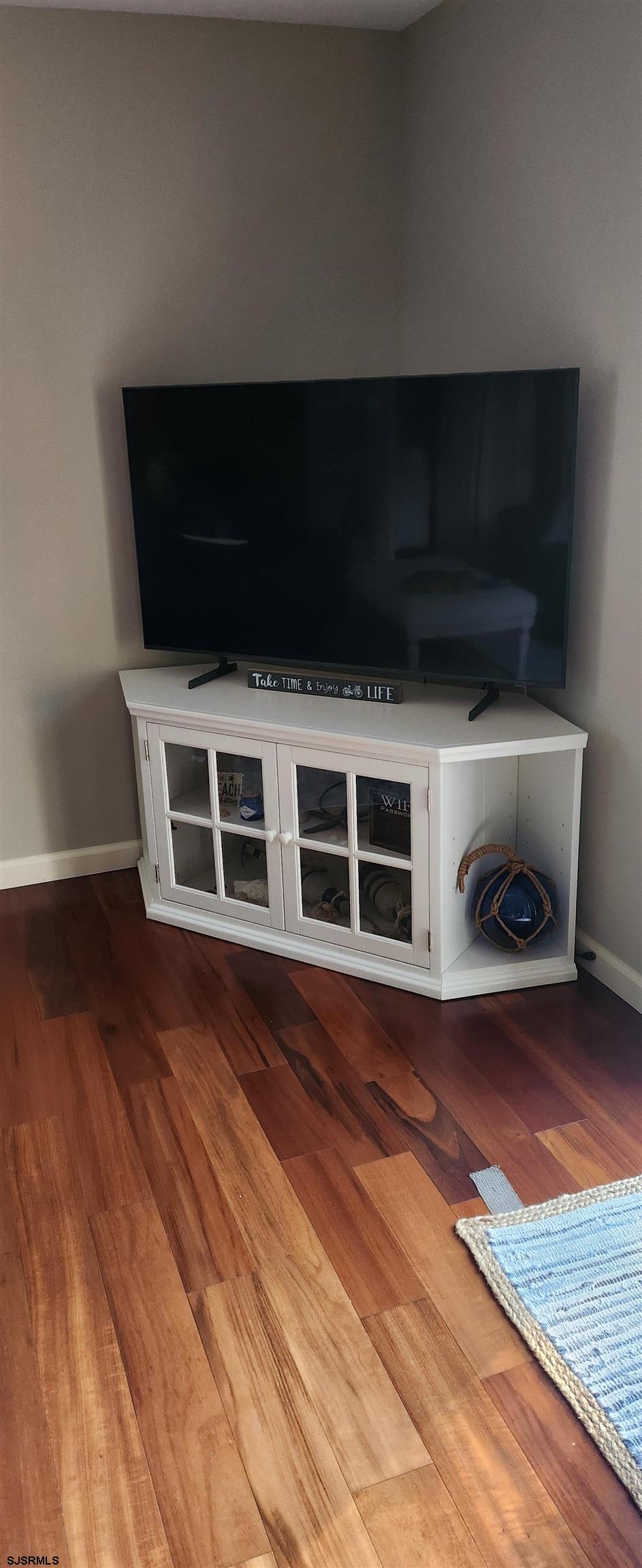 5217 Harbor Beach Boulevard, Unit SEA POINT Brigantine, NJ 08203 - Photo 8 of 38 a living room with a flat screen tv and a rug