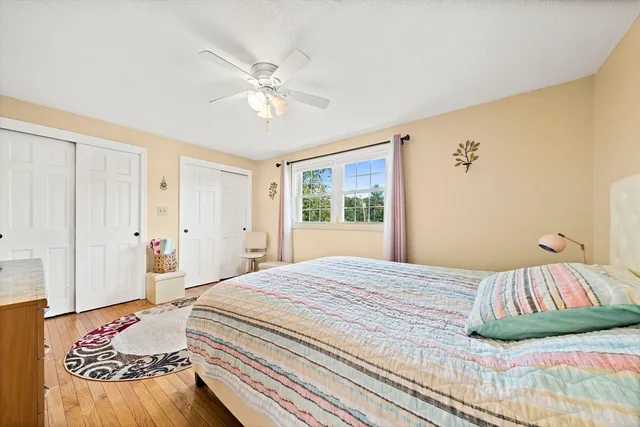 a bedroom with a large bed and a chandelier