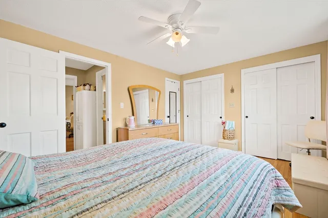 a bedroom with a large bed and a chandelier