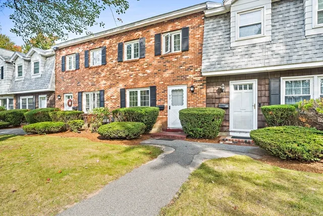 a front view of a house with yard and garage