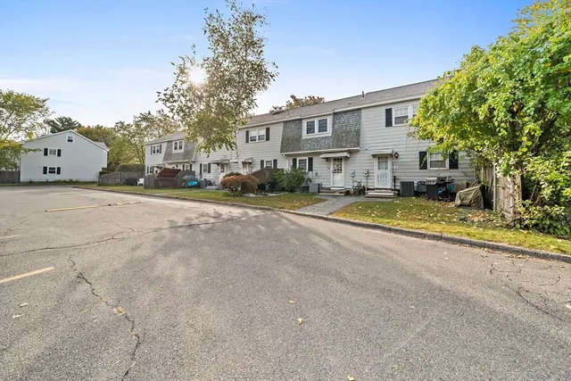 a view of a street with a house in the background