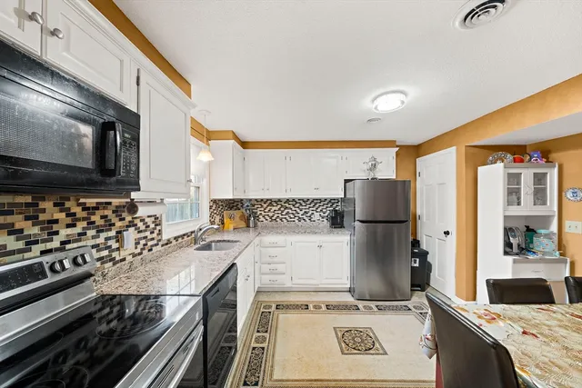 a kitchen with a stove and a refrigerator