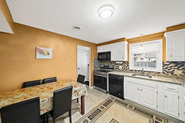 a kitchen with a stove a sink and a refrigerator