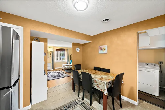 a view of a dining room with furniture and a window