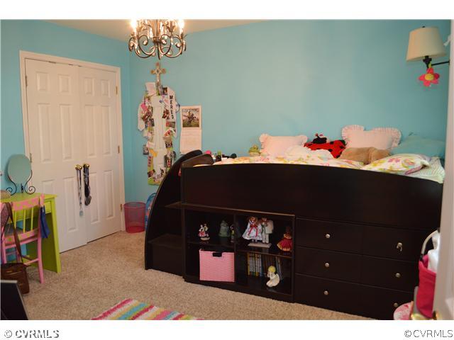 4706 Twin Cedars Road Chester, VA 23831 - Photo 14 of 24 a bedroom with a bed and a dresser