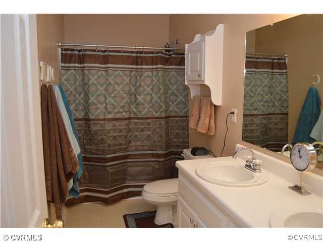 4706 Twin Cedars Road Chester, VA 23831 - Photo 15 of 24 a bathroom with a sink toilet and shower
