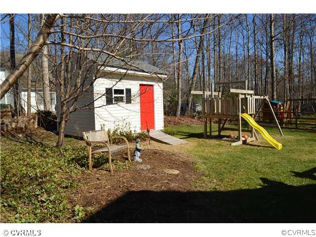 4706 Twin Cedars Road Chester, VA 23831 - Photo 20 of 24 a view of a house with backyard and a slide