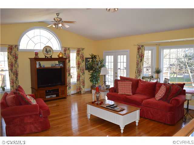 4706 Twin Cedars Road Chester, VA 23831 - Photo 8 of 24 a living room with furniture a large window and a flat screen tv